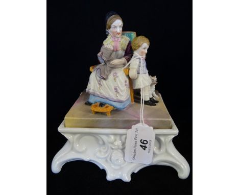 A Continental ceramic inkstand, circa 1890, having a bisque figural group to cover, the lid revealing an ink pot and sand sha
