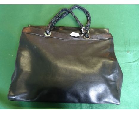 A ladies Italian black leather handbag from Piazza Sempione, Milan, having three internal sections (one zipped) with two rope
