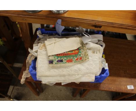 A box of old lace tablecloths and textiles