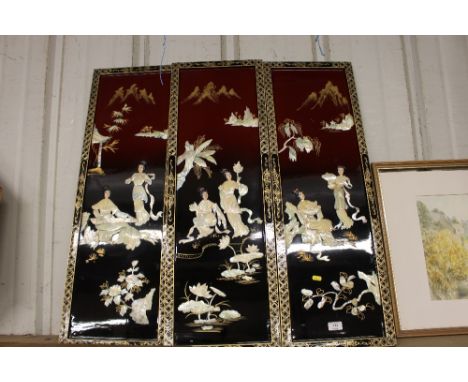 Three oriental lacquered and mother of pearl inlaid panels 
