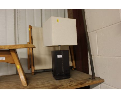 A leather table lamp and shade; together with a folding back rest 