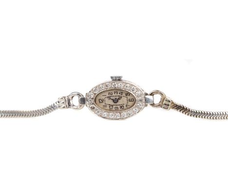 LADY'S EARLY 20TH CENTURY DIAMOND SET MANUAL WIND COCKTAIL WATCHthe oval cream dial with Arabic hour markers, inner seconds t