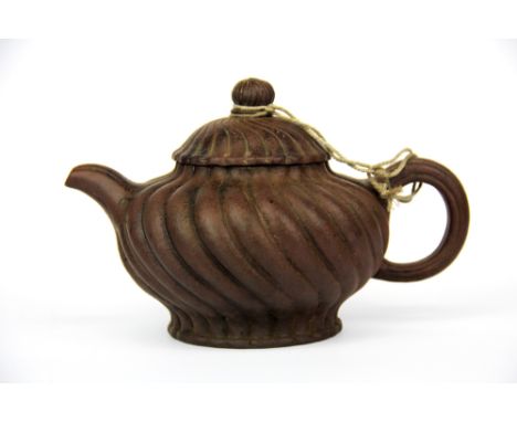 A Chinese Yixing terracotta teapot, H. 11cm, spout to handle 18cm.