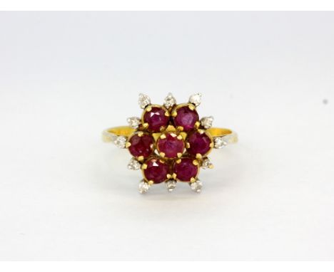 An 18ct yellow gold cluster ring set with rubies and diamonds, (N).