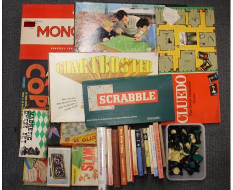 Two chess sets, a match chess clock, and a quantity of chess related books together with a group of other board games.