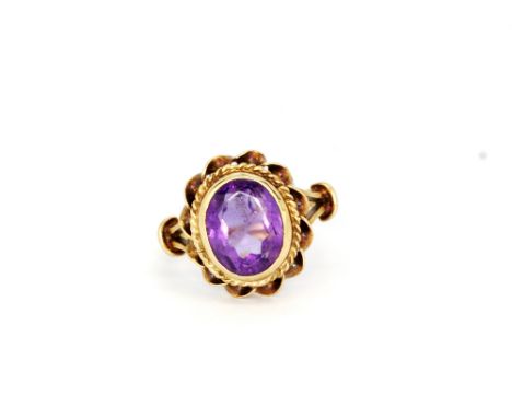 A 9ct yellow gold oval cut amethyst set ring, (K).