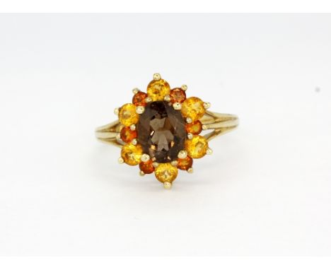 A 9ct yellow gold cluster ring set with smokey quartz and citrines, (N).