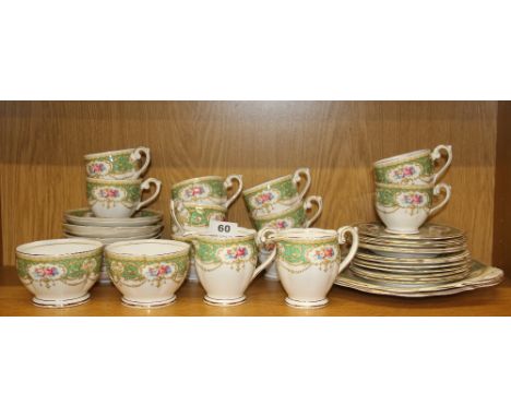 An extensive Queen Anne 'Regency' pattern tea set including 10 cups, 12 saucers, 12 tea plates, two sandwich plates, two suga