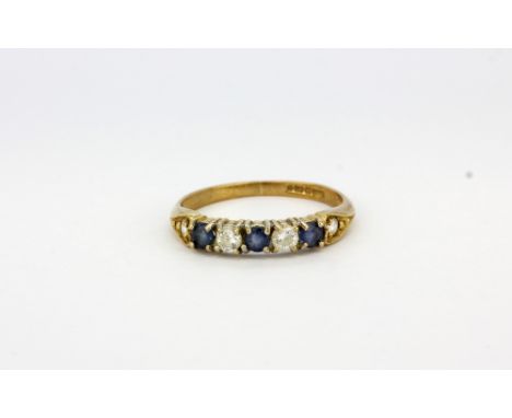 A 9ct yellow gold sapphire and white stone set half eternity ring, (L.5).