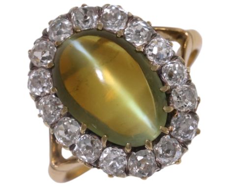 An Antique 18ct gold cats eye chrysoberyl and diamond cluster ring, late 19th century, set with a 4.15ct oval cabochon chryso