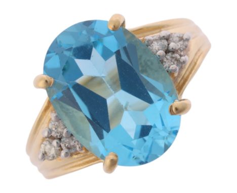 A 14ct gold blue topaz and diamond ring, claw set with oval mixed-cut topaz flanked by a trio of modern round brilliant-cut d