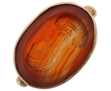 A hardstone intaglio ring, possibly Antique, the oval panel carved depicting male profile, in 9ct gold ring mount, agate appr