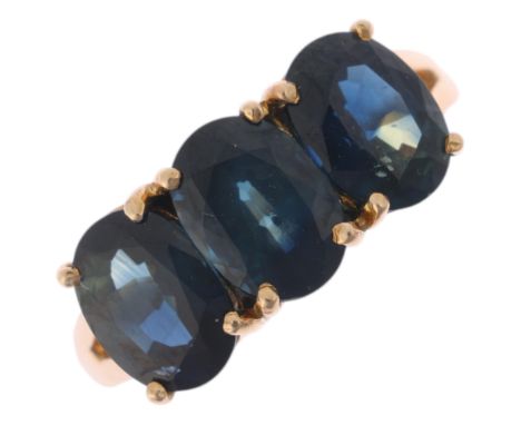 A 14ct gold three stone sapphire dress ring, claw set with oval mixed-cut sapphires, setting height 7.3mm, size K, 2.8g . Con