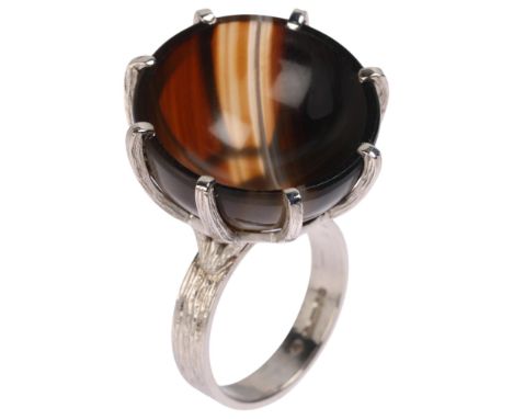 A Vintage 9ct white gold banded agate cup ring, maker CW, London 1979, set with round polished concave cup-shaped banded agat