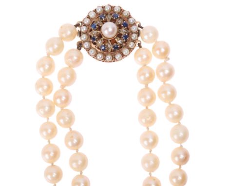 A Vintage double-strand cultured pearl bead necklace, with 9ct rose gold sapphire and pearl flowerhead clasp, unmarked mount 