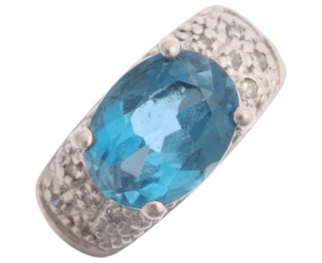 A 9ct white gold blue topaz and diamond dress ring, claw-set with oval mixed cut topax and diamond shoulders, settings height