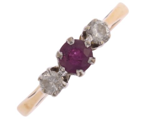 An 18ct gold three stone ruby and diamond ring, maker TL, London 1977, claw set with round-cut ruby and modern round brillian