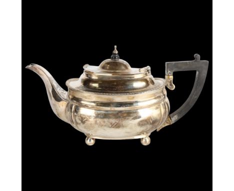 A George V silver teapot, Charles Stuart Harris, London 1926, oval bulbous form, with gadrooned rim and turned wood handle an
