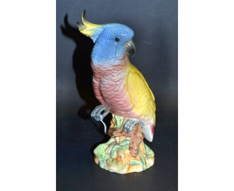 A Beswick model of a Cockatoo, number 1180, glazed in yellow and blue, 21cm high