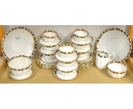 A Edwardian tea service, comprising bread and butter plates, side plates, cream jug, sugar bowl, slope bowl, cups and saucers