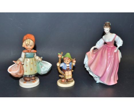 A Goebel figure, large, girl with baskets; another, Apple Tree boy; a Royal Doulton figure, Fair Lady (coral pink), HN2835 (3