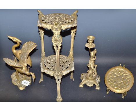 Brassware - A two tier what-not; a figural candle stick; an Islamic type dish; a model of a pair of cranes (4)