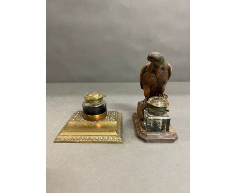A wooden eagle inkwell and a brass inkwell 