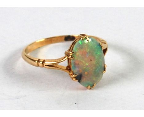 GOLD RING (MARK RUBBED) CLAW SET with an oval opal, 2.1 gms