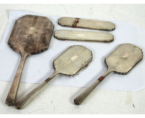 GEORGE V ENGINE TURNED SILVER CASED 5 PIECE DRESSING TABLE HAND MIRROR  AND BRUSH SET, Birmingham 1934, the four brushes all 