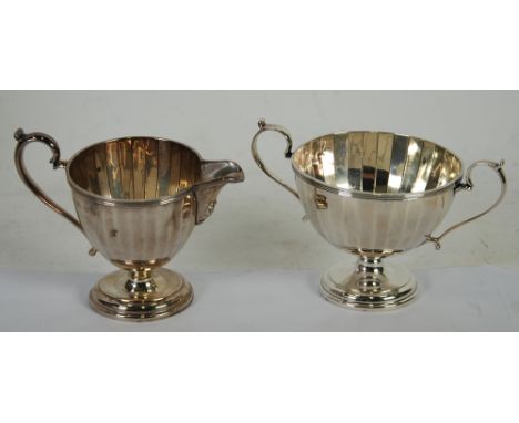 EARLY 20th CENTURY SILVER PEDESTAL TWO HANDLED SUGAR BASIN of panelled circular shape, with matching CREAM JUG, Birmingham 19