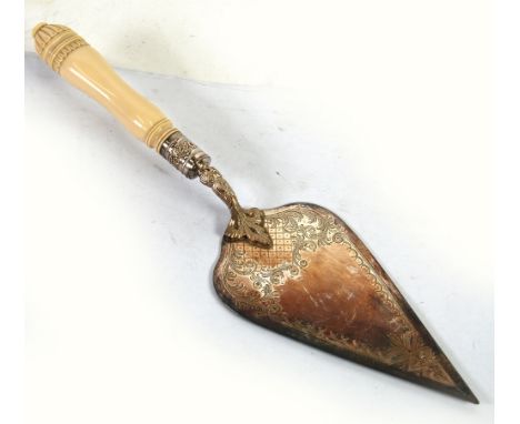 AN EDWARDIAN ELECTROPLATE TROWEL with bright cut engraved triangular blade on a foliate chase curved shaft, with floral repou