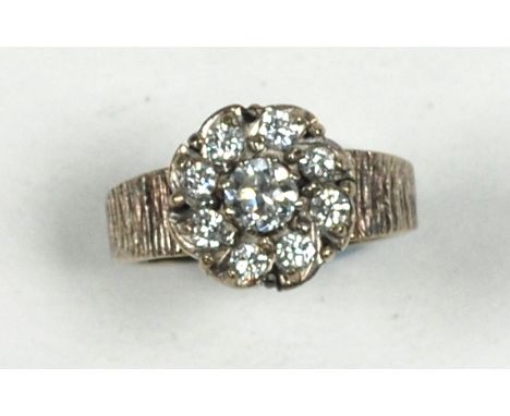18ct GOLD AND DIAMOND DAISY CLUSTER RING set with a centre round, brilliant cut diamond, approximately .33ct and a surround o