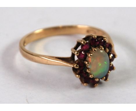 9ct GOLD, OPAL AND GARNET CLUSTER RING, set with a central oval opal and surround of 12 garnets, London hallmark 1984, 2.2gms