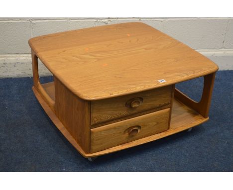 AN ERCOL MODEL 735 BLONDE ELM PANDORA BOX OCCASIONAL TABLE, with two drawers and book storage, on orbit casters, 81cm squared