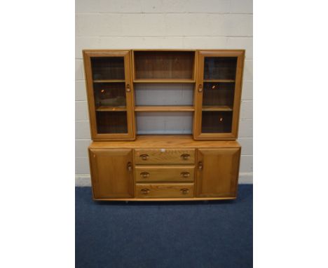 AN ERCOL MODEL 455D BLONDE ELM WINSOR SIDEBOARD/DISPLAY CABINET, the top section with double bevelled glass doors flanking an