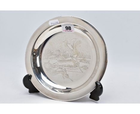A SILVER DISH, engraved ducks in mid flight scene to the centre of the dish, plain polished rim, hallmarked London 1972 'John