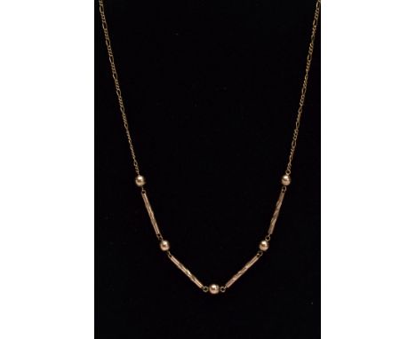 A LATE 20TH CENTURY 9CT GOLD NECKLET, designed with four engraved detailed bars interspaced with ball links, fitted onto a fi