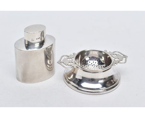 A SILVER TEA STRAINER AND TEA CADDY, the tea strainer with double openwork handles hallmarked Birmingham 1964, with a plain p