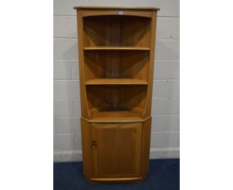 AN ERCOL MODEL 743C BLONDE ELM OPEN CORNER CUPBOARD, above a single cupboard door, width 76cm x depth 41cm x height 180cm (go