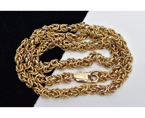 A YELLOW METAL HEAVY CHAIN, byzantine chain designed with plain and textured multi joined circular links, fitted with a lobst