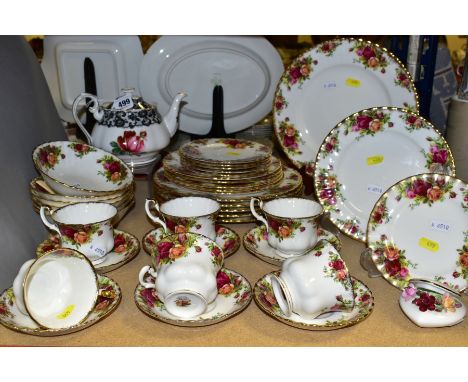 A ROYAL ALBERT OLD COUNTRY ROSES PART DINNER SERVICE AND A ROYAL ALBERT 'SENORITA' PATTERN TEAPOT, which has a small chip to 