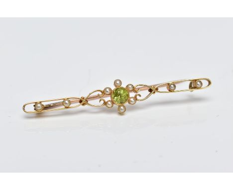 A YELLOW METAL, PERIDOT AND SPLIT PEARL BROOCH, designed with a central circular cut collet set peridot within a split pearl 