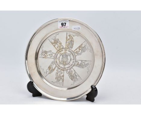 A SILVER COMMEMORATIVE SALVER, of a circular form engraved gilt detailed dragons and lion head centre inscribed '1982 Commemo