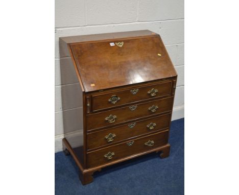 A REPRODUCTION WALNUT BUREAU, with a fitted interior, above four exterior drawers, on bracket feet, width 77cm x depth 47cm x