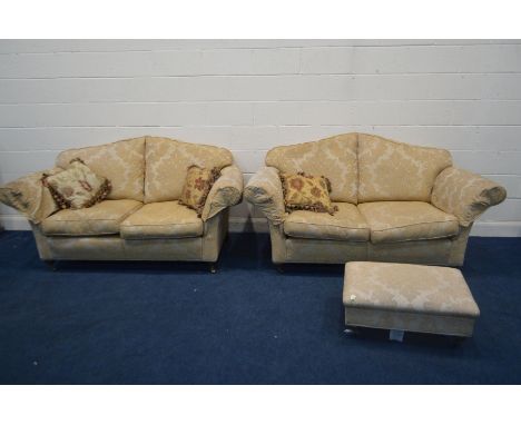 A DURESTA GOLD FOLIATE UPHOLSTERED THREE PIECE SUITE, on bulbous and brass caps and casters, comprising two  seater settees, 