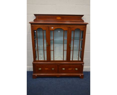 AN EDWARDIAN STYLE MAHOGANY AND BOX STRUNG GLAZED THREE DOOR BOOKCASE, above two deep drawers, width 125cm x depth 30cm x hei