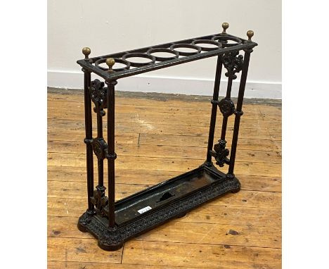 A Victorian cast iron stick stand, possibly Coalbrookdale, with six divisions and original tray, stamped with Victorian regis