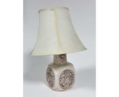 A 1970s style pottery cream glazed octagonal panel sided lamp with Rune style circular impressed panels complete with shade, 