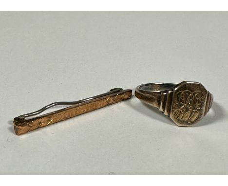 A 9ct gold gentleman's tie pin with engine turned decoration, (L: 4.5cm) and a white and yellow metal signet style ring with 