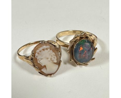 A 9ct dress ring set oval cameo, (O), and a yellow metal opal cabouchon ring with scrolling 1970s style mount, (O), unmarked,